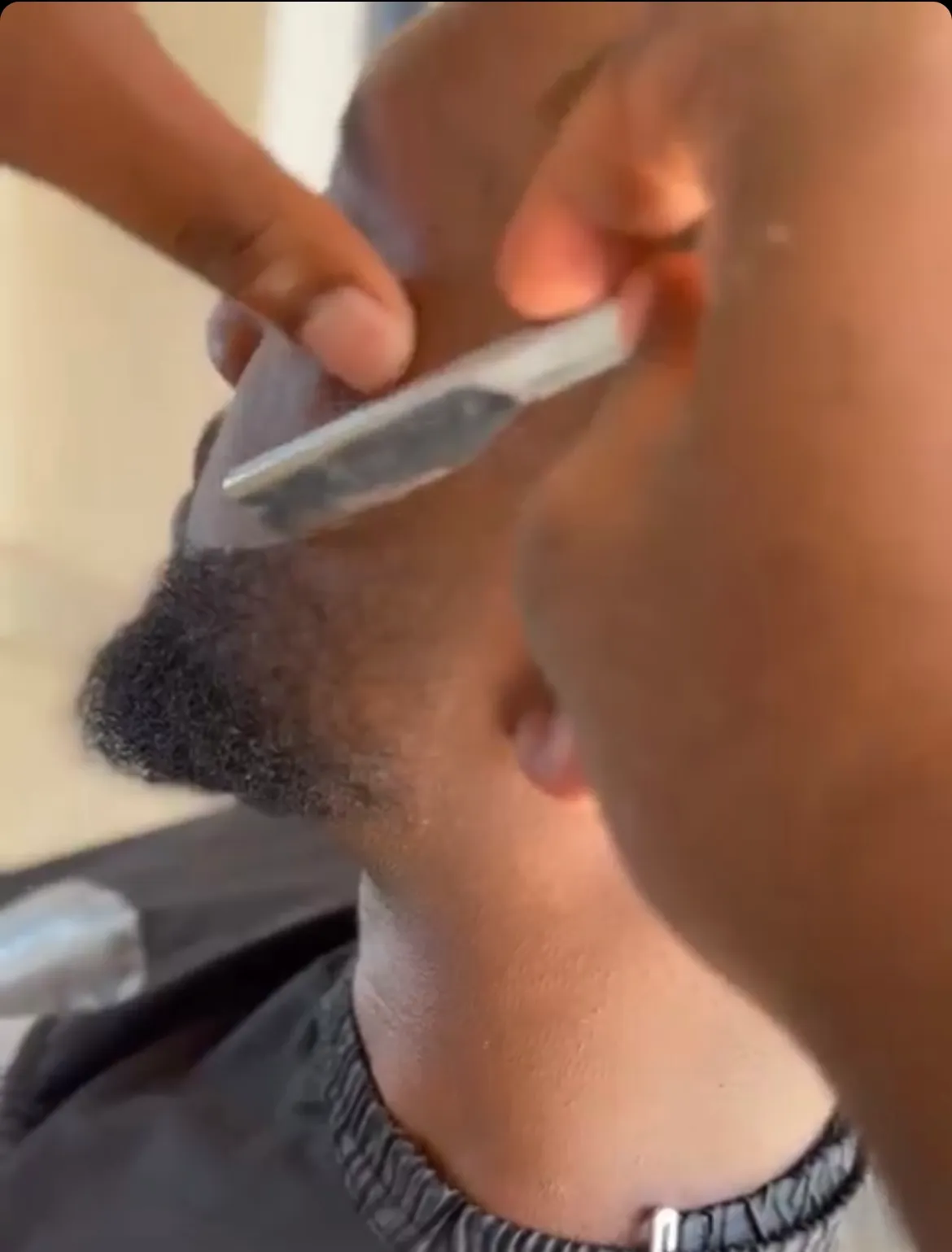 Moses shaping a beard line-up